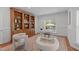 Home office featuring custom built-in shelving, a desk, and two upholstered chairs at 101 Quarryrock Rd, Holly Springs, NC 27540
