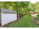 Well-maintained shed in a green, landscaped yard, offering additional storage space at 101 Quarryrock Rd, Holly Springs, NC 27540