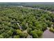 A lush, green aerial view showcases the neighborhood and the home nestled among the trees at 102 Turnberry Ln, Cary, NC 27518