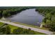 Panoramic aerial shot of the lake featuring a lakeside community with lush surroundings and a scenic road at 102 Turnberry Ln, Cary, NC 27518
