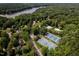 Overhead view showcasing community amenities including a pool, tennis courts, and lush landscaping near the water at 102 Turnberry Ln, Cary, NC 27518