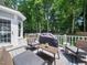Back deck featuring outdoor seating, a grill, and views of the trees at 102 Turnberry Ln, Cary, NC 27518