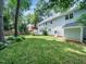 Backyard with a well-maintained lawn, inviting patio, and mature trees, creating a serene setting at 102 Turnberry Ln, Cary, NC 27518