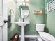 Stylish powder room features green walls, a pedestal sink, and a classic design at 102 Turnberry Ln, Cary, NC 27518