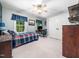 Bedroom with neutral walls, ceiling fan, large closet, and windows bringing in natural light at 102 Turnberry Ln, Cary, NC 27518