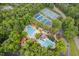Aerial shot highlighting the neighborhood's amenities, including tennis courts and a community pool at 102 Turnberry Ln, Cary, NC 27518