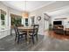 Sunlit dining nook with round table, neutral walls, and direct access to the main living area at 102 Turnberry Ln, Cary, NC 27518