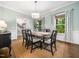 Comfortable dining area with a wooden table, chair set, window views and a modern lighting fixture at 102 Turnberry Ln, Cary, NC 27518