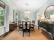 Elegant dining room with stylish furnishings, ample natural light, and a view of the outdoors at 102 Turnberry Ln, Cary, NC 27518