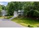 A light blue two-story home with an attached garage and a well-maintained lawn and driveway at 102 Turnberry Ln, Cary, NC 27518