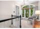 Hallway nook with a large window and chair offers a bright and inviting space at 102 Turnberry Ln, Cary, NC 27518