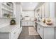 Bright, fully-equipped kitchen with white cabinets, stainless steel appliances, and granite countertops at 102 Turnberry Ln, Cary, NC 27518
