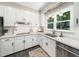 A clean, modern kitchen boasts white cabinetry, subway tile backsplash, and stainless steel appliances at 102 Turnberry Ln, Cary, NC 27518