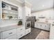 A well-appointed kitchen features a built-in microwave/oven, white cabinets, and granite countertops at 102 Turnberry Ln, Cary, NC 27518