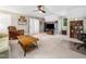 Spacious living room featuring plush carpet, a large wood table, and a unique ceiling fan at 102 Turnberry Ln, Cary, NC 27518