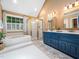 The primary bathroom features double sinks, a gold-framed shower, and a separate tub at 102 Turnberry Ln, Cary, NC 27518