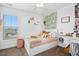 Charming bedroom with stylish decor, large window, carpet floors, and modern ceiling fan at 102 Williamson Place Dr, Princeton, NC 27569