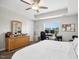 Primary bedroom with ceiling fan, large window, dresser, and ensuite at 102 Williamson Place Dr, Princeton, NC 27569