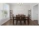 Bright dining room features wood floors, decorative shelving, and a dining table for six at 102 Williamson Place Dr, Princeton, NC 27569