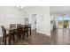 Open dining room with wood floors leading to a kitchen with stainless appliances at 102 Williamson Place Dr, Princeton, NC 27569