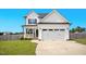 Inviting two-story home with a covered front porch and an attached two-car garage at 102 Williamson Place Dr, Princeton, NC 27569