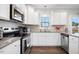 Close-up of a modern kitchen with stainless steel appliances and granite countertops at 102 Williamson Place Dr, Princeton, NC 27569