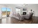 Bright living room with a fireplace, patio access, and comfortable seating at 102 Williamson Place Dr, Princeton, NC 27569