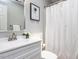 Bathroom with a vanity, a framed art piece and shower-tub combination with a white curtain at 103 Summerlin Dr Dr, Chapel Hill, NC 27514