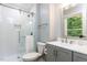 Bathroom with a walk-in shower with glass doors, white subway tile and a modern vanity at 103 Summerlin Dr Dr, Chapel Hill, NC 27514