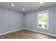 Bright bedroom features neutral walls, recessed lighting, and a window with a lush view at 103 Summerlin Dr Dr, Chapel Hill, NC 27514