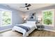 Bright bedroom featuring a ceiling fan, two windows, and neutral decor at 103 Summerlin Dr Dr, Chapel Hill, NC 27514