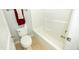 The bathroom contains a white toilet, a white tiled tub, and a towel rack with colorful towels at 1041 Pemberly Ave, Morrisville, NC 27560