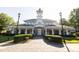 Exterior of the community clubhouse with manicured bushes, clocktower, and ample parking at 1041 Pemberly Ave, Morrisville, NC 27560