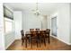 Sunlit dining area features hardwood floors, a modern chandelier, and views to backyard at 1041 Pemberly Ave, Morrisville, NC 27560