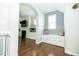 Inviting entryway with a window seat and storage, flowing into the living room with fireplace at 1041 Pemberly Ave, Morrisville, NC 27560
