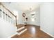 A home's entryway featuring hardwood floors, staircase, and a decorative mirror and table at 1041 Pemberly Ave, Morrisville, NC 27560