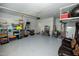 Spacious two-car garage with painted floor and ample storage shelving at 1041 Pemberly Ave, Morrisville, NC 27560