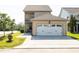 Exterior view of a two-story home featuring an attached garage and well-maintained lawn at 1041 Pemberly Ave, Morrisville, NC 27560