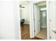 Hallway view between office and bathroom featuring hardwood floors and neutral paint at 1041 Pemberly Ave, Morrisville, NC 27560