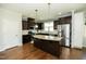 Modern kitchen with center island, stainless steel appliances, and adjacent dining area at 1041 Pemberly Ave, Morrisville, NC 27560