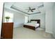 The main bedroom has a ceiling fan and a beautiful tray ceiling with grey trim at 1041 Pemberly Ave, Morrisville, NC 27560