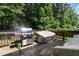 Outdoor back deck space including a grill and a table, ideal for barbecuing at 105 Everam Ct, Chapel Hill, NC 27516