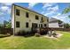Spacious backyard featuring a deck, a brick patio, and lush green grass at 105 Everam Ct, Chapel Hill, NC 27516