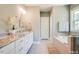 Elegant bathroom with dual sink vanity, soaking tub, marble countertops, and modern fixtures at 105 Everam Ct, Chapel Hill, NC 27516