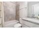 Bright bathroom featuring granite countertop vanity and tiled shower-tub combination at 105 Everam Ct, Chapel Hill, NC 27516