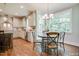 Charming breakfast nook featuring chandelier lighting, stainless appliances, and large windows at 105 Everam Ct, Chapel Hill, NC 27516