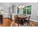 Cozy kitchen breakfast nook featuring a round table, chandelier lighting, and bright windows at 105 Everam Ct, Chapel Hill, NC 27516