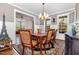 Elegant dining room featuring chandelier lighting, classic wood trim and access to other living spaces at 105 Everam Ct, Chapel Hill, NC 27516