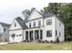 Charming two-story home with white siding, black framed windows, and a well-manicured lawn at 105 Everam Ct, Chapel Hill, NC 27516