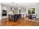 Bright, open kitchen featuring granite countertops, an island with seating, and a breakfast nook with windows at 105 Everam Ct, Chapel Hill, NC 27516